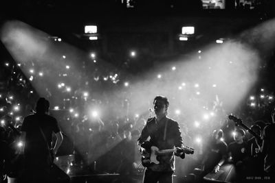 People enjoying music concert at night