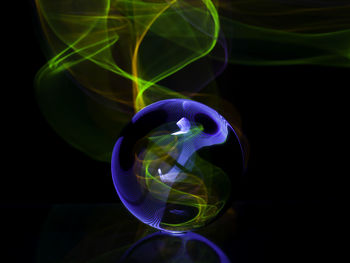 Close-up of illuminated ball against black background