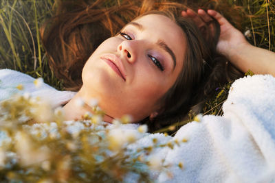 Portrait of woman lying down on bed