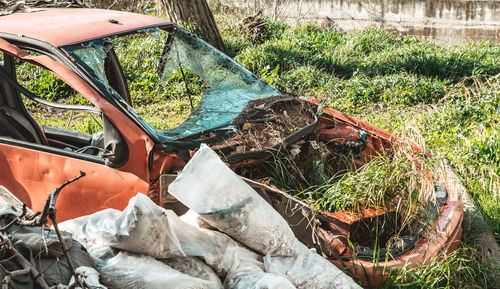 Abandoned car on field