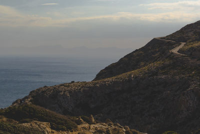 Scenic view of mountain and sea against sky