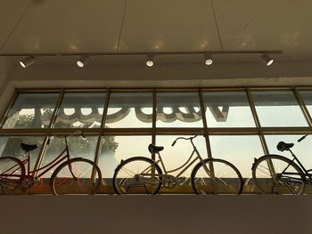 Low angle view of bicycle hanging on wall