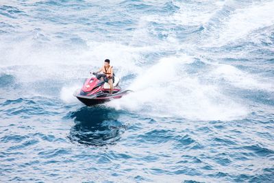 Man riding horse in sea