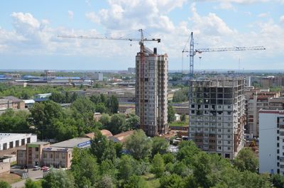 Cityscape against cloudy sky