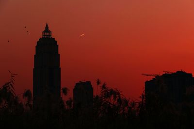 Low angle view of silhouette buildings against sky during sunset