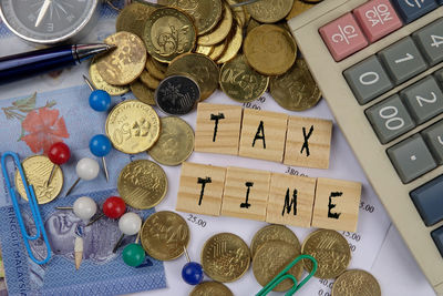 Close-up of coins with office supplies