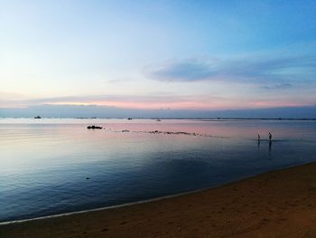 Scenic view of sea against sky at sunset