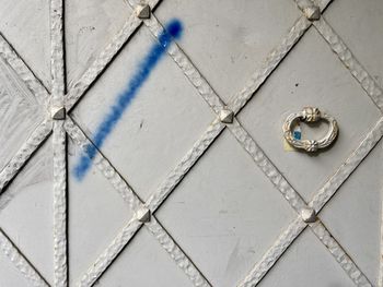 Close-up of metallic door on tiled floor