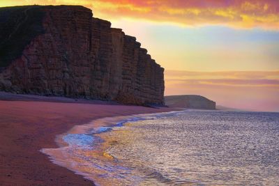 Scenic view of sea against sky during sunrise west bay dorset 