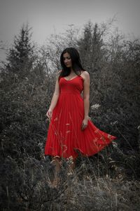 Portrait of young woman standing in forest