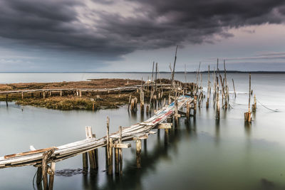 Pier in sea against sky