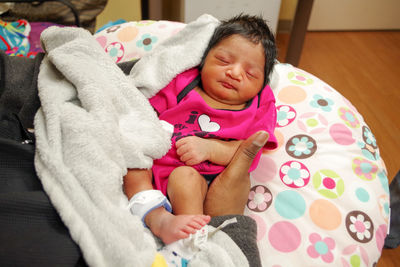 Portrait of cute baby sleeping on bed