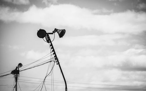 Low angle view of cables against clouds