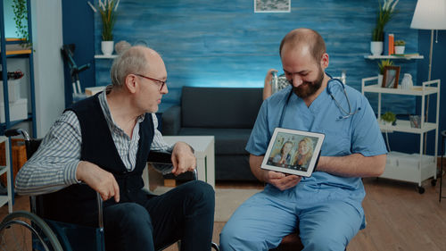 Doctor helping patient to video call