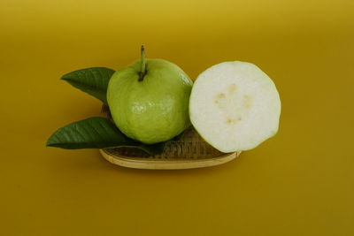 High angle view of apples against yellow background