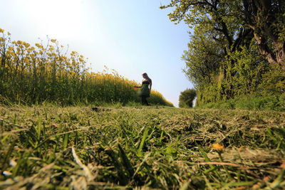 Woman on field against sky