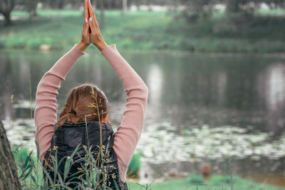 Young woman practicing yoga in park. mental health, wellness and reconnecting with nature concept.