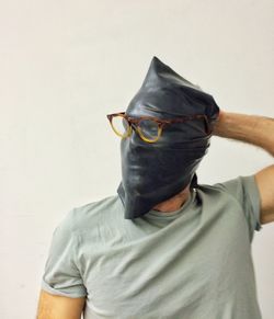 Close-up of man wearing sunglasses against white background