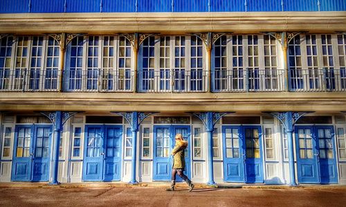 Full length of man standing on balcony in city