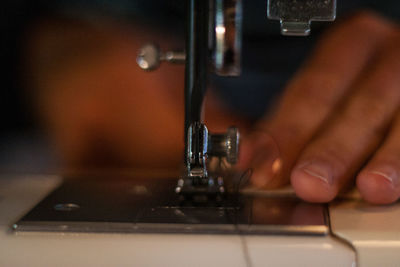 Close-up of hand using machine