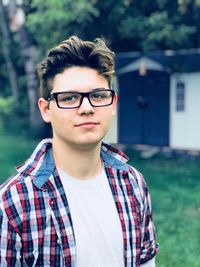 Portrait of teenage boy wearing eyeglasses outdoors