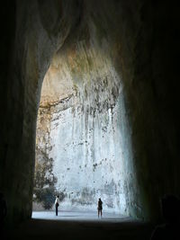 Silhouette man standing in cave