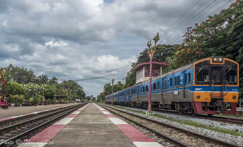Train on railroad tracks against sky