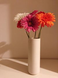 Close-up of pink flower vase on table