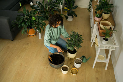 High angle view of woman standing by potted plants