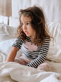 Cute girl lying on bed at home