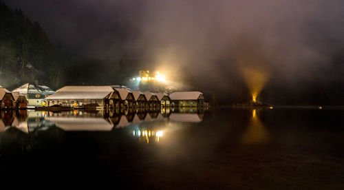 Panoramic view of illuminated lights on lake at night