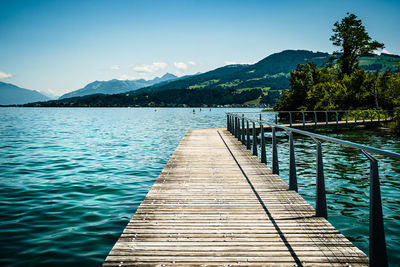 Pier over lake against sky