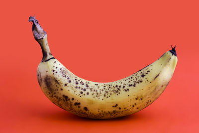 Close-up of banana on red background