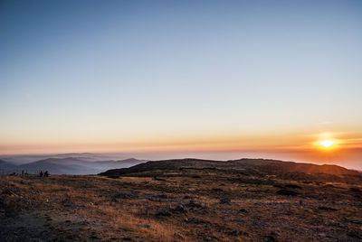 Scenic view of desert against sky during sunset
