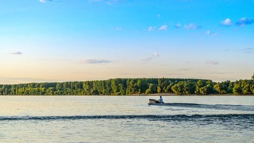 Scenic view of river against sky during sunset