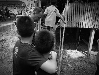 Rear view of father with son standing outdoors