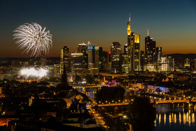 Fireworks mainfest frankfurt in front of illuminated city skyline