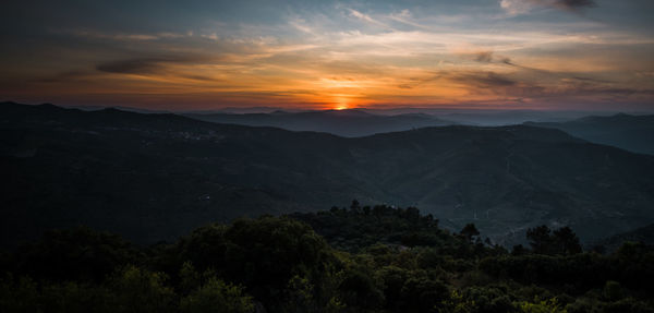Scenic view of mountains against dramatic sky