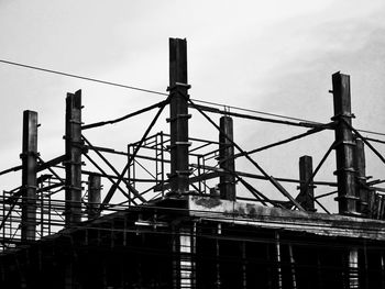 Low angle view of crane against sky