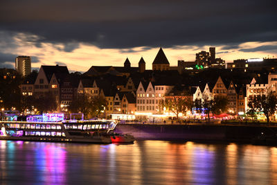 Colorfully illuminated cologne old town and the banks of the rhine at night in cologne
