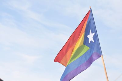 Low angle view of catalonian rainbow flag against sky