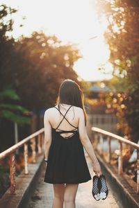 Rear view of woman standing in park