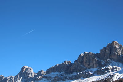 Low angle view of mountains against clear blue sky