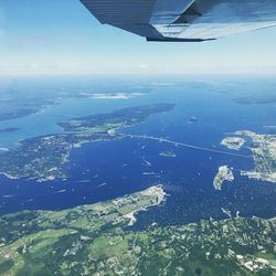 Aerial view of airplane wing over sea