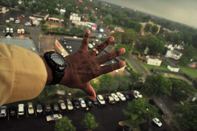 Close-up of hand holding city