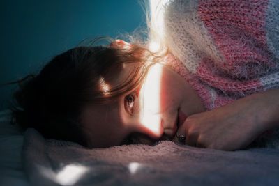 Portrait of woman lying on bed