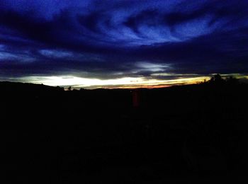 Silhouette of landscape against sunset sky