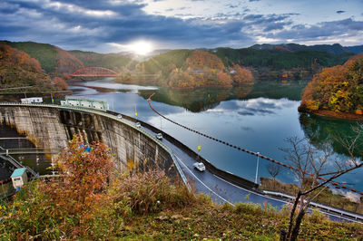 Scenic view of bridge over river against sky during autumn