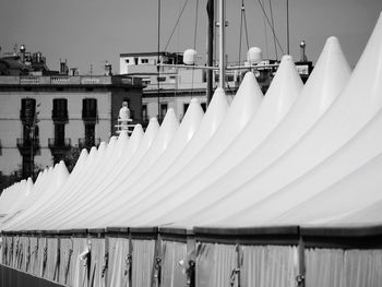 Panoramic view of boats moored in lake against buildings