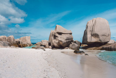 Rocks on beach against sky